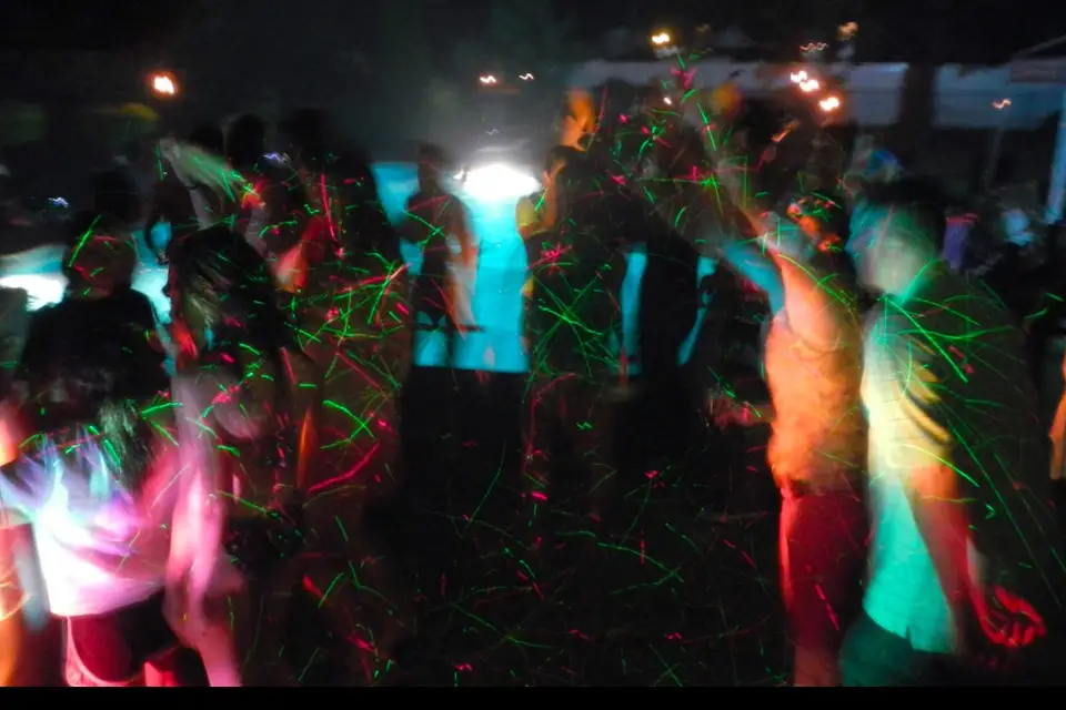 Wild laser lights by the pool dancing to techno music